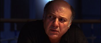 Movie still from “12” (2007), directed by Nikita Mikhalkov – An older man with a bald head looking at the camera; Close Up shot, Low angle