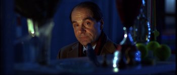 Movie still from “12” (2007), directed by Nikita Mikhalkov – A person wearing a suit and tie; Close Up shot, Low angle