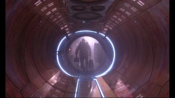 Movie still from “12 Monkeys” (1995), directed by Terry Gilliam – A man is walking through a tunnel in a building; Wide shot, Low angle