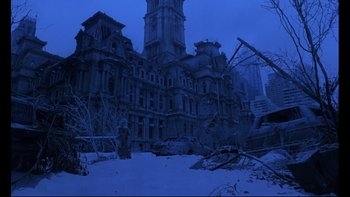 Movie still from “12 Monkeys” (1995), directed by Terry Gilliam – An old building in the middle of a snowy field; Extreme Wide shot, Low angle