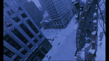 Movie still from “12 Monkeys” (1995), directed by Terry Gilliam – An aerial view of a city with snow on the ground; Extreme Wide shot, Overhead angle