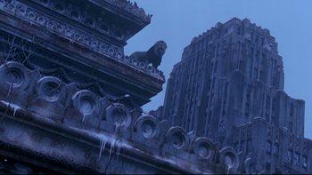 Movie still from “12 Monkeys” (1995), directed by Terry Gilliam – A lion sitting on top of an old building; Extreme Wide shot, Low angle