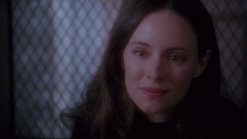 Movie still from “12 Monkeys” (1995), directed by Terry Gilliam – A person with long dark hair; Close Up shot, Over the shoulder angle