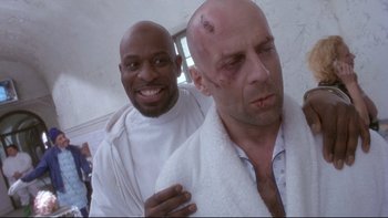 Movie still from “12 Monkeys” (1995), directed by Terry Gilliam – A bald man with a shaved head and a bald man with a shaved head; Medium shot, Low angle