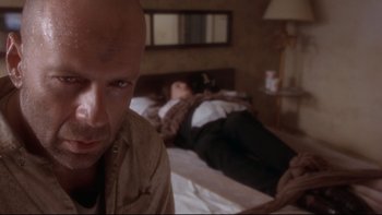 Movie still from “12 Monkeys” (1995), directed by Terry Gilliam – A man and a woman laying on a bed; Close Up shot, Low angle