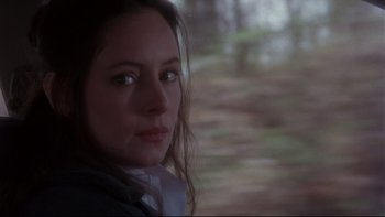 Movie still from “12 Monkeys” (1995), directed by Terry Gilliam – A person with long brown hair; Close Up shot, Over the shoulder angle