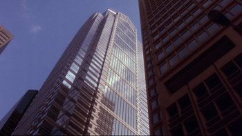 Movie still from “12 Monkeys” (1995), directed by Terry Gilliam – Looking up at a skyscraper in a city; Extreme Wide shot, Low angle