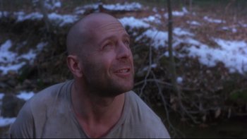 Movie still from “12 Monkeys” (1995), directed by Terry Gilliam – A bald man is looking up at the sky; Close Up shot, Low angle