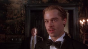 Movie still from “12 Monkeys” (1995), directed by Terry Gilliam – A person wearing a suit and a bow tie; Close Up shot, Low angle