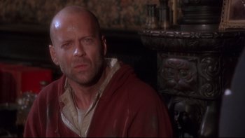 Movie still from “12 Monkeys” (1995), directed by Terry Gilliam – A bald man in a red hooded sweatshirt; Close Up shot, Low angle