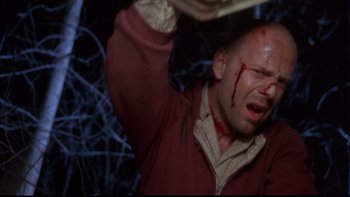 Movie still from “12 Monkeys” (1995), directed by Terry Gilliam – A man with blood all over his face and head; Close Up shot, Low angle
