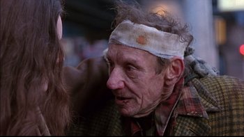 Movie still from “12 Monkeys” (1995), directed by Terry Gilliam – An old man with a bandage on his head; Close Up shot, Over the shoulder angle