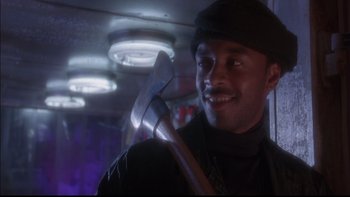 Movie still from “12 Monkeys” (1995), directed by Terry Gilliam – A man holding an axe in a room; Close Up shot, Low angle