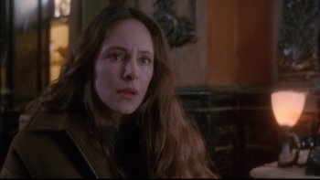 Movie still from “12 Monkeys” (1995), directed by Terry Gilliam – A person with long brown hair; Close Up shot, Over the shoulder angle