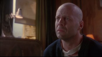 Movie still from “12 Monkeys” (1995), directed by Terry Gilliam – A bald man is looking into the distance; Close Up shot, Low angle