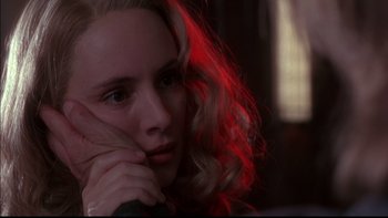 Movie still from “12 Monkeys” (1995), directed by Terry Gilliam – A woman with blonde hair sitting in front of a window; Close Up shot, Over the shoulder angle