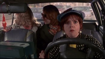 Movie still from “12 Monkeys” (1995), directed by Terry Gilliam – Three women are driving in a car in a parking lot; Medium shot, Over the shoulder angle