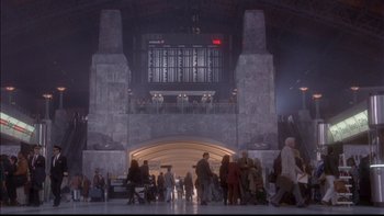 Movie still from “12 Monkeys” (1995), directed by Terry Gilliam – A group of people walking through a train station; Extreme Wide shot, Low angle