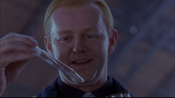 Movie still from “12 Monkeys” (1995), directed by Terry Gilliam – A person holding a fork; Close Up shot, Over the shoulder angle