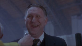 Movie still from “12 Monkeys” (1995), directed by Terry Gilliam – A person wearing a suit and tie; Close Up shot, Low angle