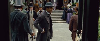 Movie still from “12 Years a Slave” (2013), directed by Steve McQueen – A group of people in old - fashioned clothing on a sidewalk; Medium shot, Over the shoulder angle