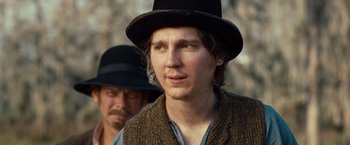 Movie still from “12 Years a Slave” (2013), directed by Steve McQueen – A man wearing a hat and a brown jacket; Close Up shot, Over the shoulder angle