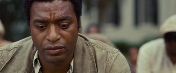 Movie still from “12 Years a Slave” (2013), directed by Steve McQueen – A person wearing a jacket; Close Up shot, Over the shoulder angle