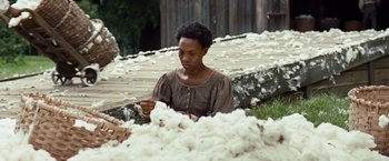 Movie still from “12 Years a Slave” (2013), directed by Steve McQueen – A woman sitting in front of a pile of cotton; Medium shot, Over the shoulder angle