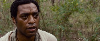 Movie still from “12 Years a Slave” (2013), directed by Steve McQueen – A person wearing a robe; Close Up shot, Over the shoulder angle
