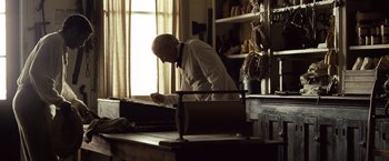 Movie still from “12 Years a Slave” (2013), directed by Steve McQueen – A man in a white shirt and a black neck tie; Medium shot, Low angle