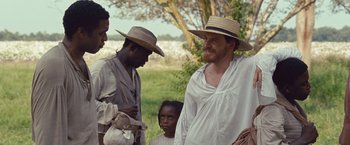 Movie still from “12 Years a Slave” (2013), directed by Steve McQueen – A group of men standing next to each other; Medium shot, Over the shoulder angle