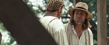Movie still from “12 Years a Slave” (2013), directed by Steve McQueen – Two men talking to each other outside in the woods; Medium shot, Over the shoulder angle