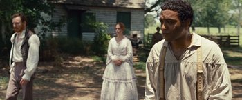 Movie still from “12 Years a Slave” (2013), directed by Steve McQueen – A man and a woman standing in front of a house; Medium shot, Over the shoulder angle