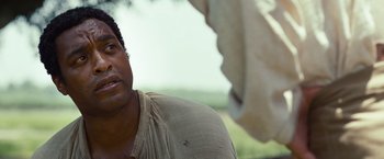 Movie still from “12 Years a Slave” (2013), directed by Steve McQueen – A person wearing a shirt; Close Up shot, Over the shoulder angle