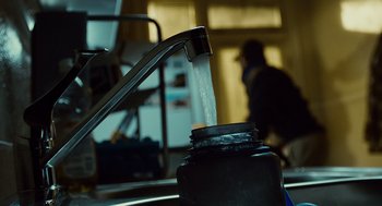 Movie still from “127 Hours” (2010), directed by Danny Boyle – A water faucet with water pouring out of it; Extreme Close Up shot, Low angle