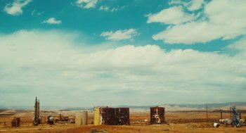 Movie still from “127 Hours” (2010), directed by Danny Boyle – A view of an industrial area in the middle of the desert; Extreme Wide shot, Low angle
