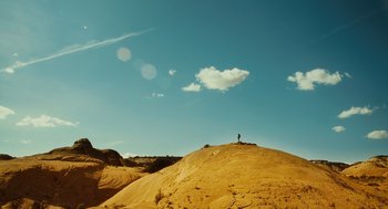Movie still from “127 Hours” (2010), directed by Danny Boyle – A person standing on top of a sand hill; Extreme Wide shot, Low angle