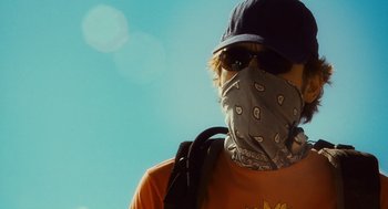 Movie still from “127 Hours” (2010), directed by Danny Boyle – A man with a bandana covering his face; Close Up shot, Low angle