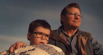 Movie still from “127 Hours” (2010), directed by Danny Boyle – An older man and a young boy wearing glasses; Close Up shot, Low angle