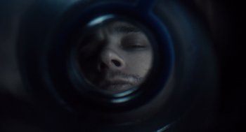 Movie still from “127 Hours” (2010), directed by Danny Boyle – A man with his eyes closed looking into a mirror; Extreme Close Up shot, Overhead angle