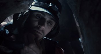 Movie still from “127 Hours” (2010), directed by Danny Boyle – A person wearing a helmet; Close Up shot, Overhead angle