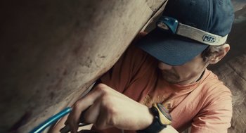 Movie still from “127 Hours” (2010), directed by Danny Boyle – A man holding a wrench in his hand while working on a wall; Close Up shot, Low angle