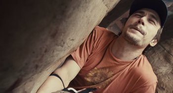 Movie still from “127 Hours” (2010), directed by Danny Boyle – A person climbing a rock wall; Close Up shot, Low angle
