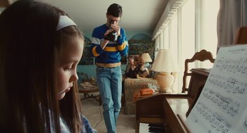 Movie still from “127 Hours” (2010), directed by Danny Boyle – A man and a little girl playing a game on a video camera; Medium shot, High angle