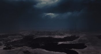 Movie still from “127 Hours” (2010), directed by Danny Boyle – A view of the ocean from a distance at night time; Extreme Wide shot, High angle