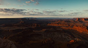 Movie still from “127 Hours” (2010), directed by Danny Boyle – An aerial view of a desert landscape at sunset; Extreme Wide shot, High angle