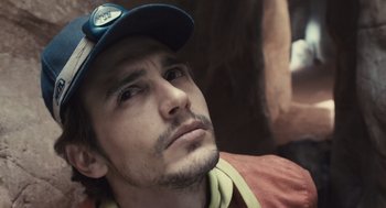 Movie still from “127 Hours” (2010), directed by Danny Boyle – A person wearing a hat; Close Up shot, Overhead angle