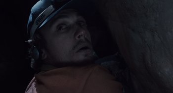 Movie still from “127 Hours” (2010), directed by Danny Boyle – A person wearing a hard hat; Close Up shot, Overhead angle