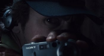Movie still from “127 Hours” (2010), directed by Danny Boyle – A man taking a picture with a camera; Extreme Close Up shot, Low angle