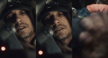 Movie still from “127 Hours” (2010), directed by Danny Boyle – A person with a microphone; Extreme Close Up shot, Overhead angle